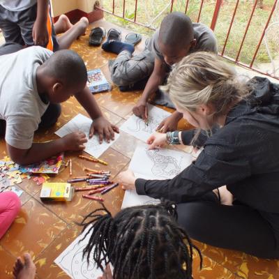 A volunteer coloring books with the children at her Childcare Project A Projects Abroad volunteer on her Spring Break Project coloring books with the children at her Childcare placement in Jamaica